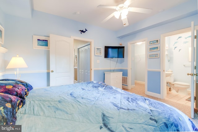 tiled bedroom featuring a closet, a spacious closet, a ceiling fan, connected bathroom, and baseboards