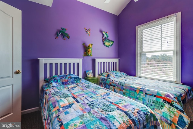 bedroom featuring a ceiling fan, vaulted ceiling, and baseboards