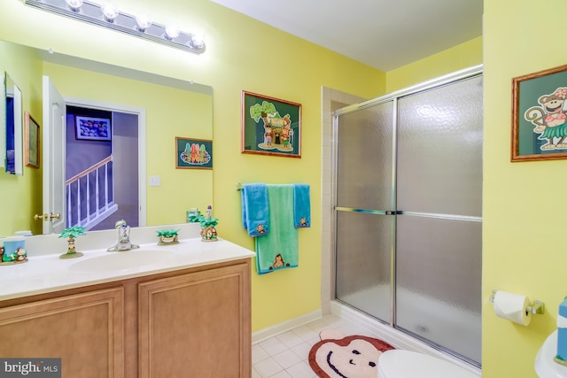 full bathroom featuring tile patterned flooring, a shower with door, vanity, and toilet