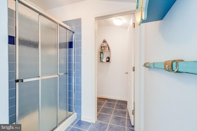 full bathroom with a stall shower and tile patterned flooring