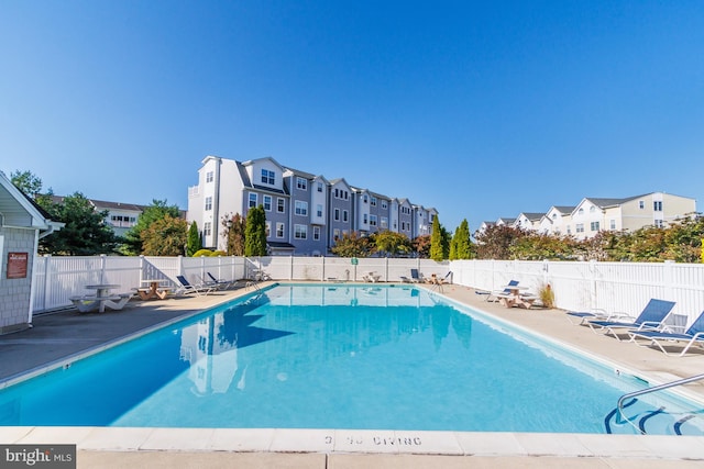 pool featuring a patio and fence