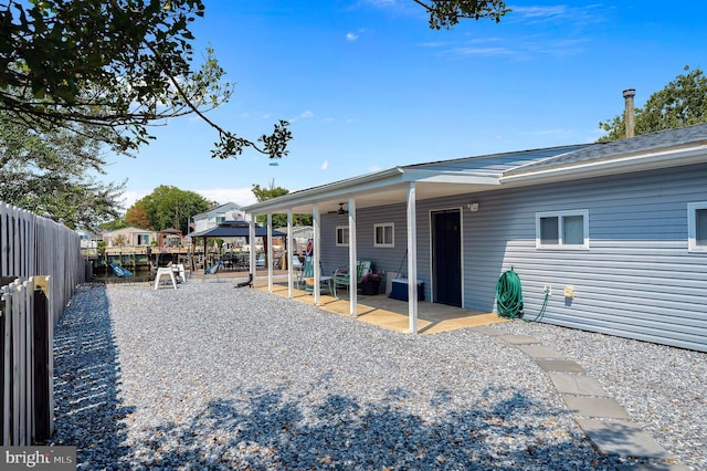 exterior space with a patio area, a playground, and a fenced backyard