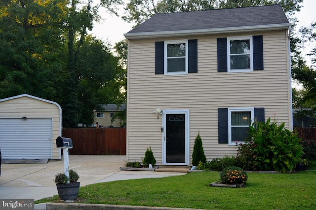 view of front facade featuring a front yard and an outdoor structure