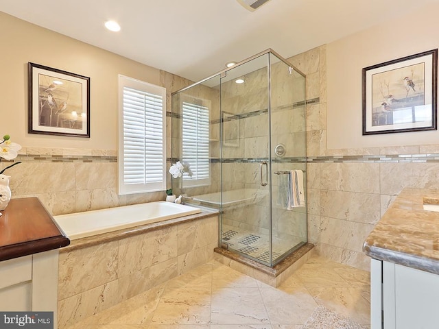 bathroom with vanity, tile walls, and plus walk in shower