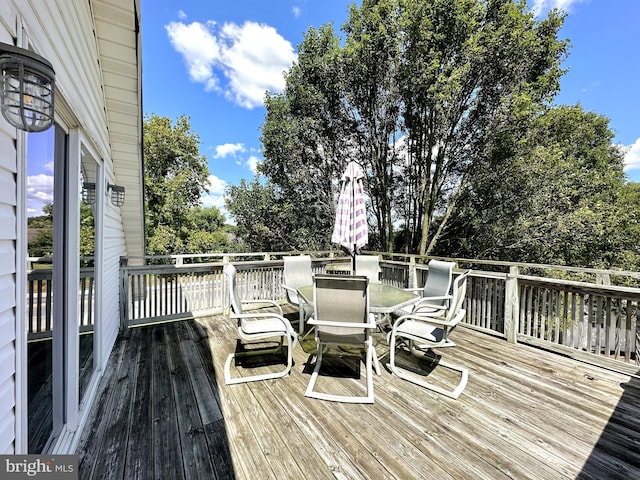 wooden deck featuring outdoor dining space