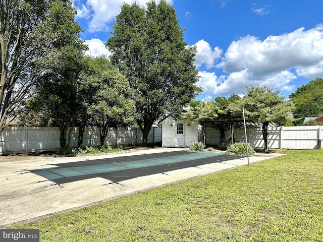 view of pool featuring a lawn, a patio area, fence, and a fenced in pool