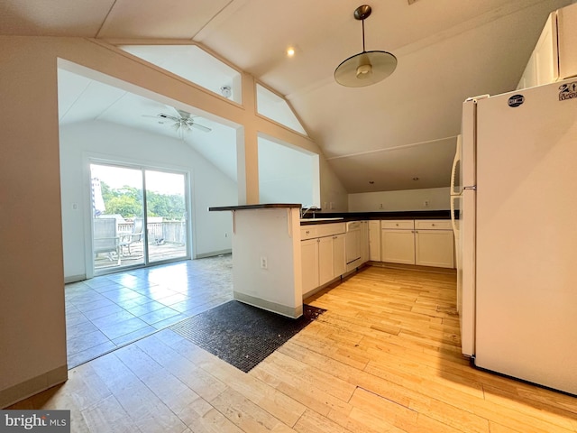 kitchen featuring ceiling fan, pendant lighting, light hardwood / wood-style floors, white fridge, and lofted ceiling