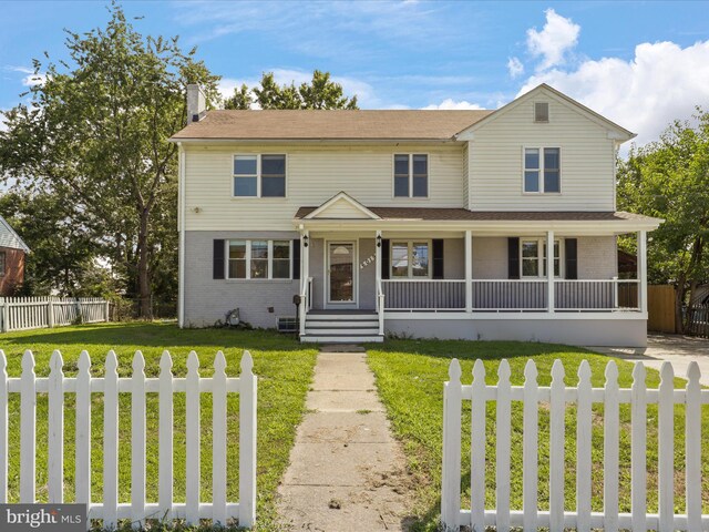 view of front of home featuring central AC unit and a front lawn