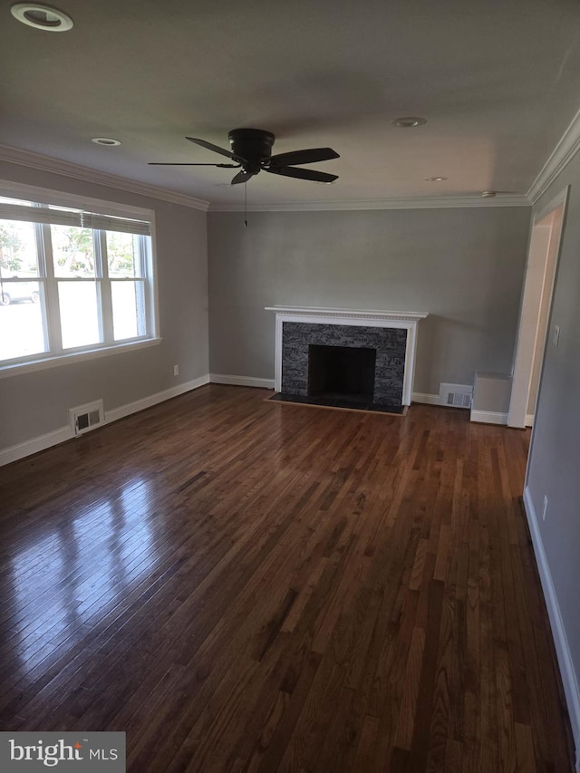 unfurnished living room featuring ceiling fan, ornamental molding, dark hardwood / wood-style flooring, and a stone fireplace