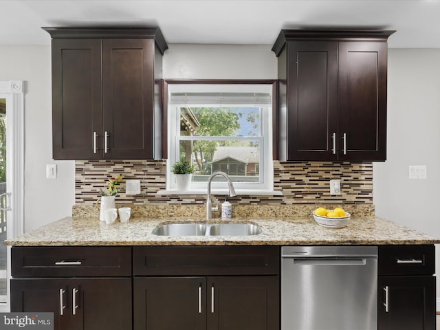 kitchen with light stone counters, a sink, dark brown cabinets, dishwasher, and tasteful backsplash