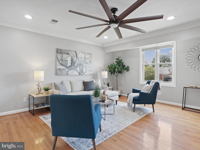 living room featuring crown molding, visible vents, and light wood-type flooring