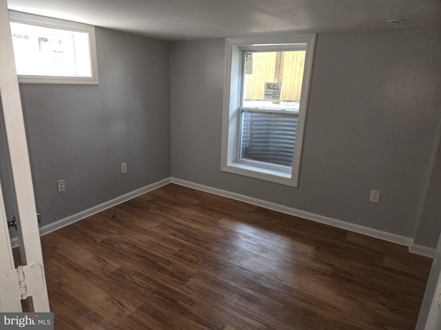 unfurnished room with dark hardwood / wood-style floors