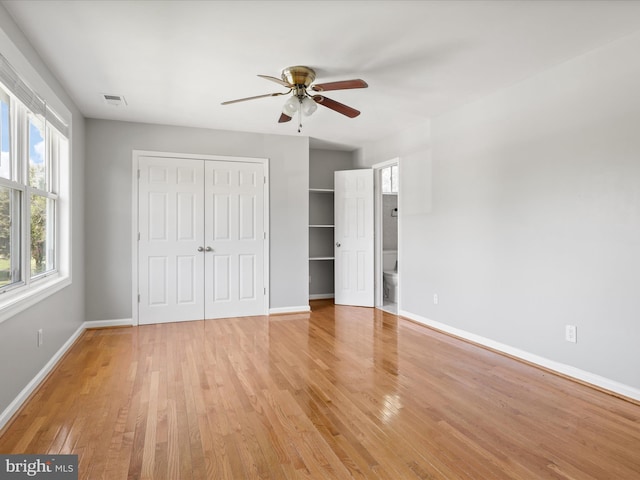 unfurnished bedroom featuring visible vents, baseboards, and light wood finished floors