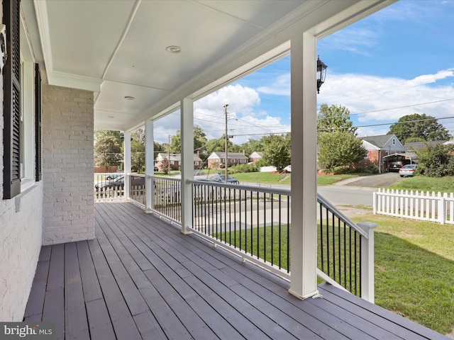 deck featuring a lawn and a porch