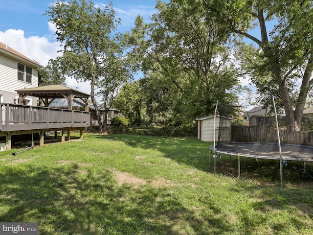 view of yard featuring a shed, a gazebo, and a trampoline