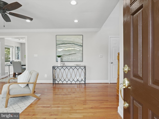 entrance foyer featuring crown molding, recessed lighting, light wood-style floors, and baseboards