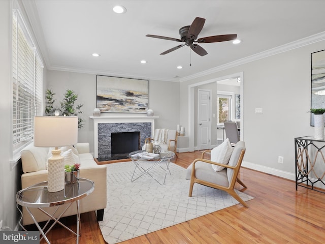 living area featuring crown molding and wood finished floors