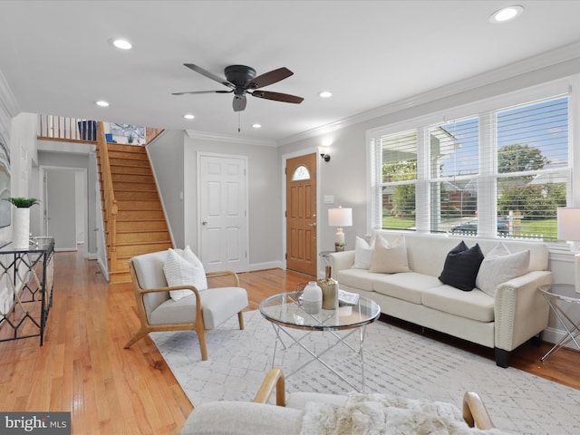 living area with stairway, recessed lighting, light wood-type flooring, and ornamental molding