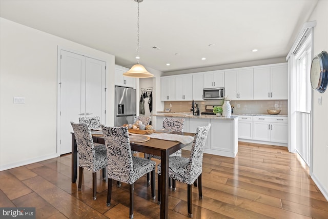 dining area featuring wood-type flooring