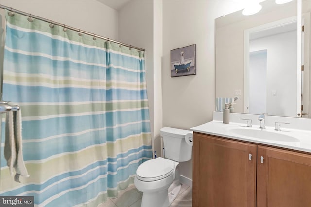 bathroom with a shower with shower curtain, toilet, tile patterned floors, and vanity