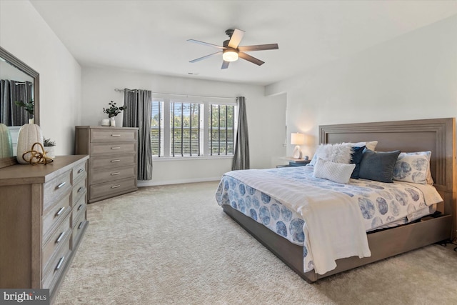 bedroom featuring ceiling fan and light carpet