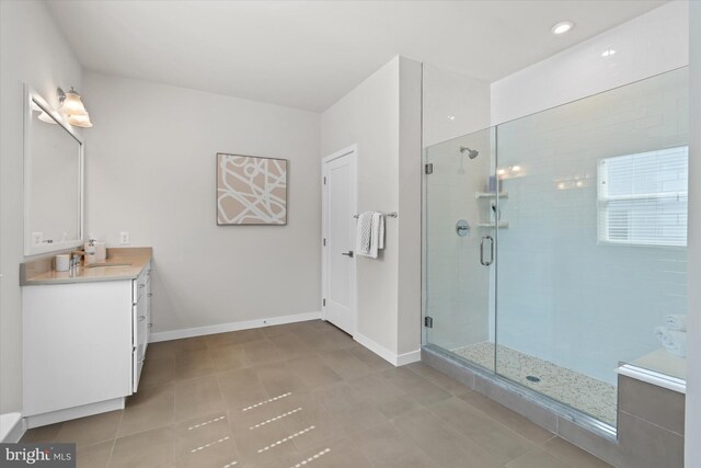 bathroom with plus walk in shower, tile patterned flooring, and vanity