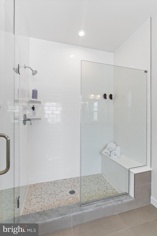 bathroom featuring walk in shower and tile patterned floors