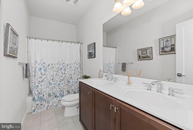 full bathroom featuring shower / tub combo with curtain, toilet, vanity, and tile patterned floors