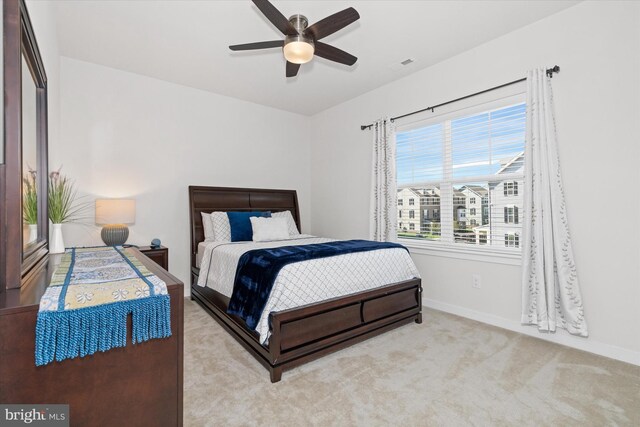 bedroom featuring ceiling fan and light carpet