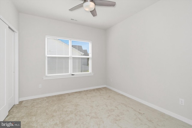 unfurnished bedroom with ceiling fan, carpet flooring, and a closet