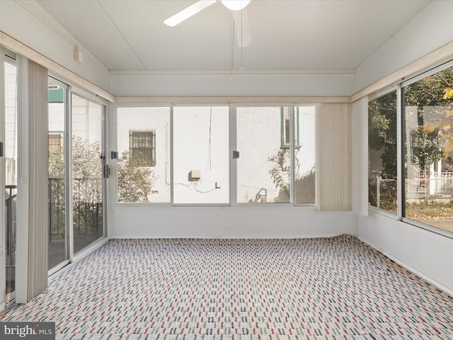 unfurnished sunroom with ceiling fan