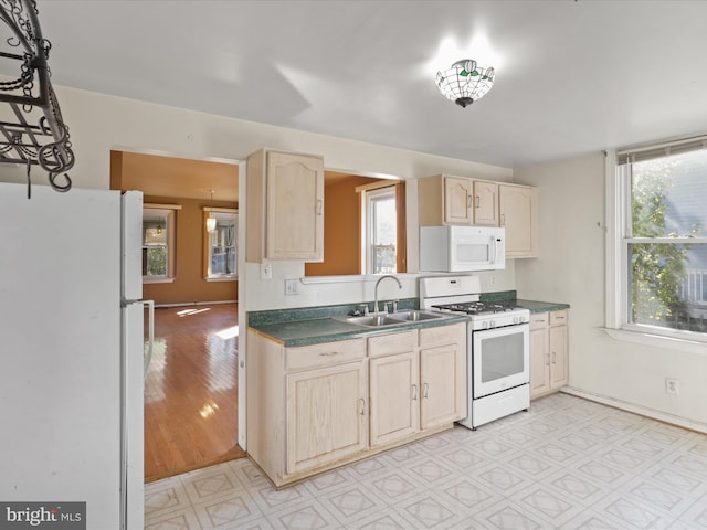 kitchen with light hardwood / wood-style flooring, sink, light brown cabinetry, and white appliances