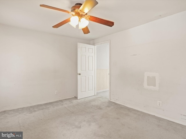 unfurnished room with light colored carpet and ceiling fan