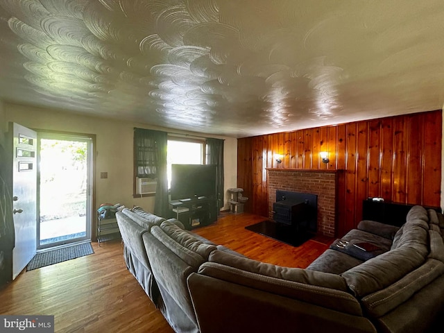 living area with wooden walls and wood finished floors