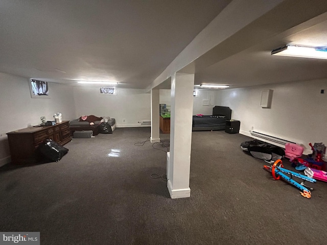 finished basement with dark colored carpet, baseboards, and a baseboard radiator