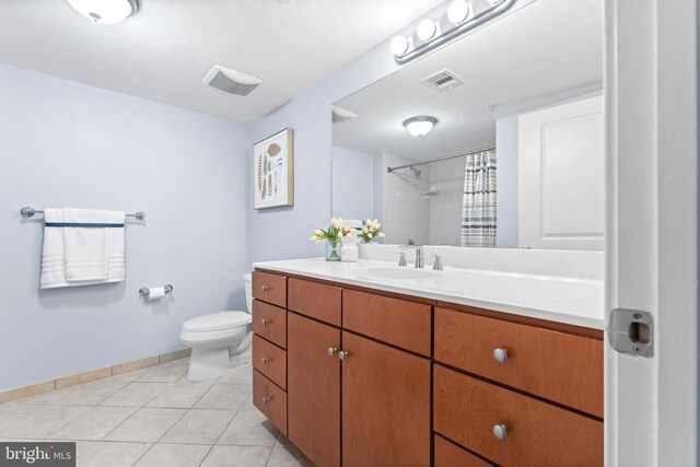 bathroom with vanity, toilet, tile patterned floors, and walk in shower