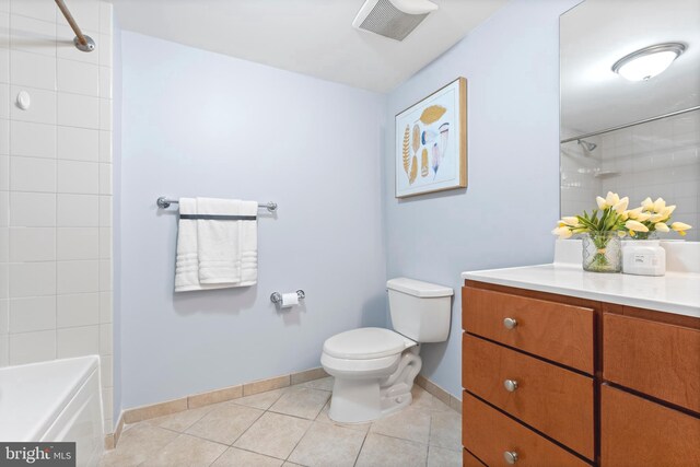 full bathroom with tiled shower / bath, vanity, toilet, and tile patterned flooring