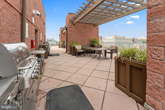 view of patio with a grill and a pergola