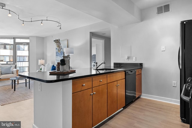 kitchen with track lighting, dishwasher, kitchen peninsula, and sink