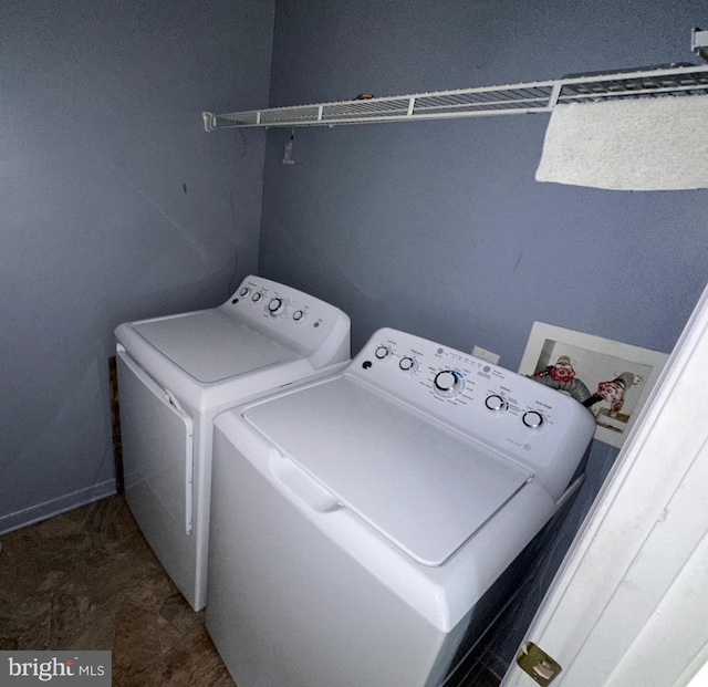 clothes washing area featuring washing machine and dryer and tile patterned flooring