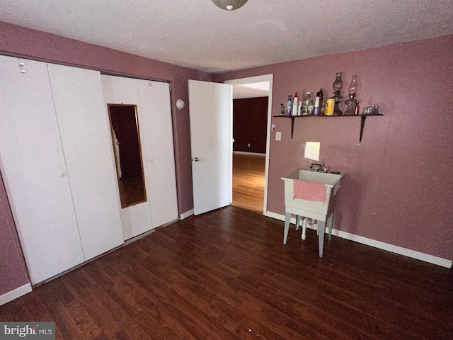 unfurnished bedroom with a textured ceiling and hardwood / wood-style floors