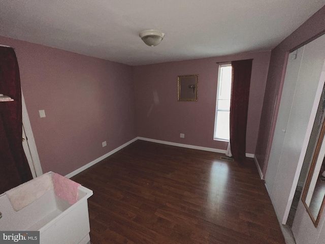 empty room with dark wood-type flooring