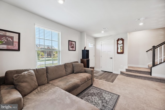 living area with baseboards, visible vents, stairway, and recessed lighting