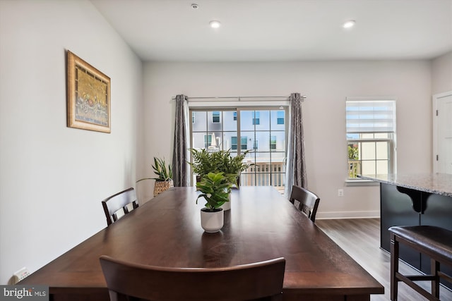 dining space featuring a wealth of natural light, dark wood-style flooring, baseboards, and recessed lighting