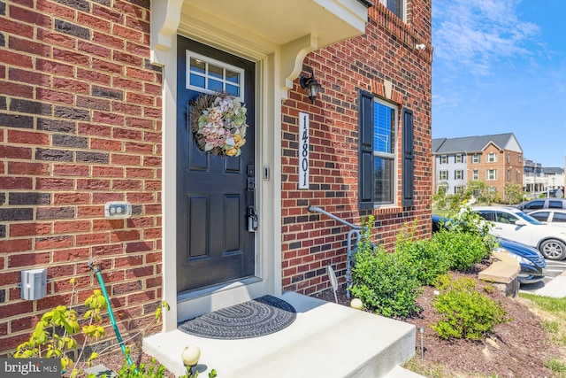 entrance to property with brick siding