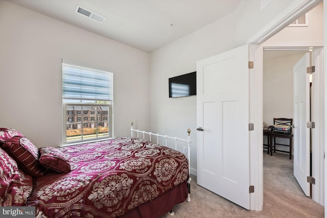 bedroom featuring light carpet