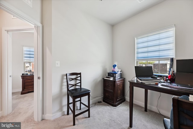 office with light carpet and baseboards