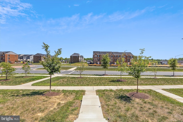 view of property's community with a residential view and a yard