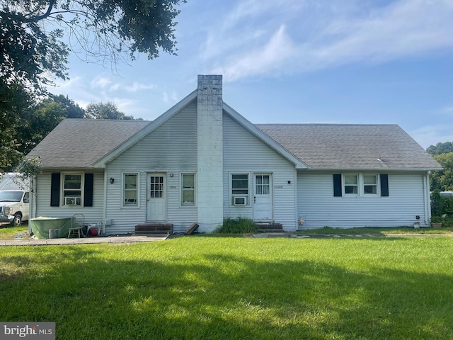 back of property featuring a yard