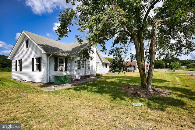 view of side of home featuring a lawn